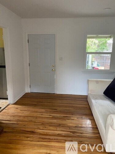 A room with wooden floors and a white door.
