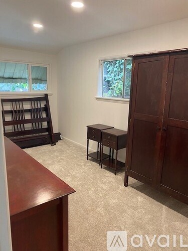 A room with a desk, a chair, and a bookshelf.