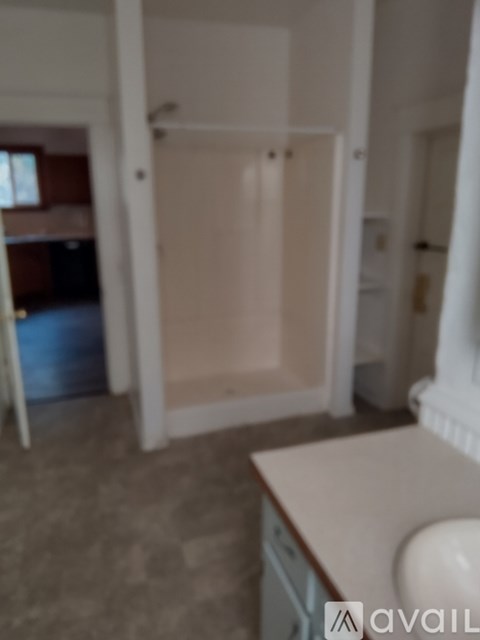 A kitchen with a counter and a fridge.