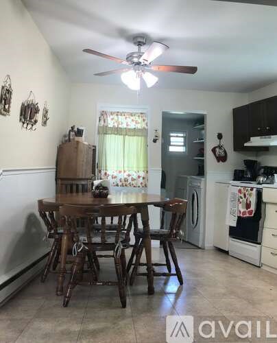 A kitchen with a table and chairs in the middle of it.
