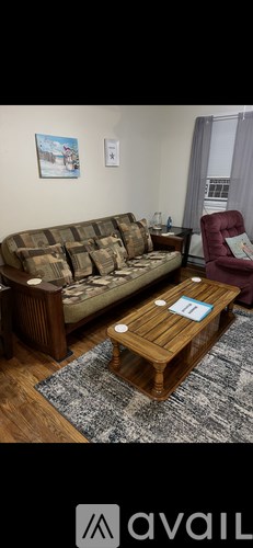 A living room with a sofa, a chair, and a coffee table.