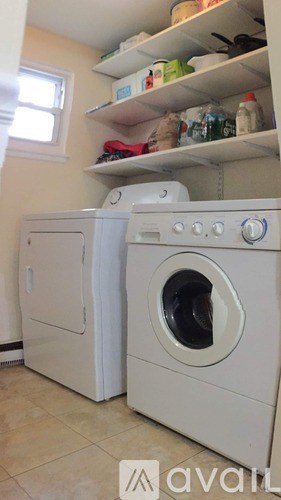 A white washing machine and dryer in a small laundry room.