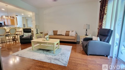 A living room with a sofa, armchair, and coffee table.