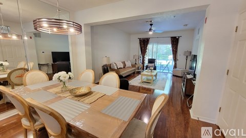 A dining room with a wooden table and chairs.