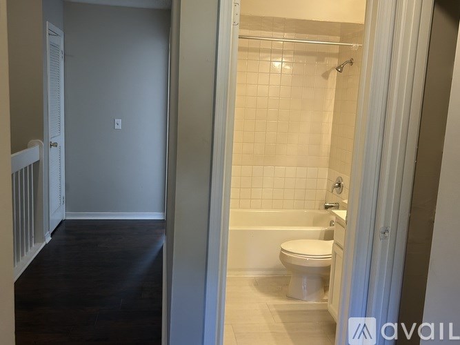 A bathroom with a toilet, tub, and shower.