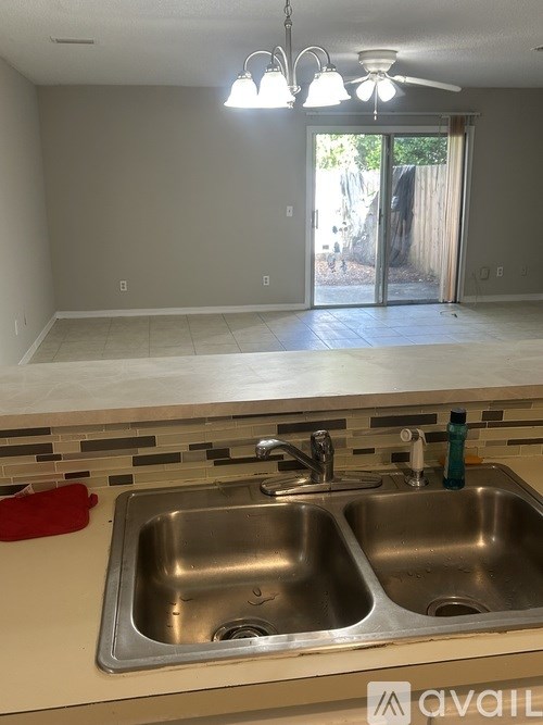 A kitchen with a double sink and a window.