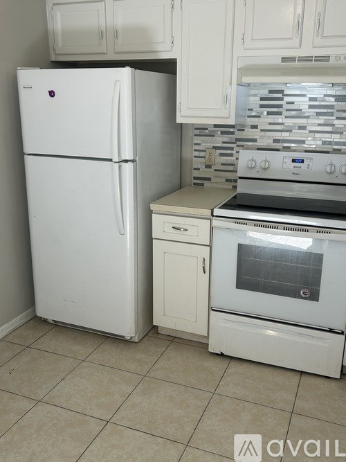 A white fridge and oven in a kitchen.