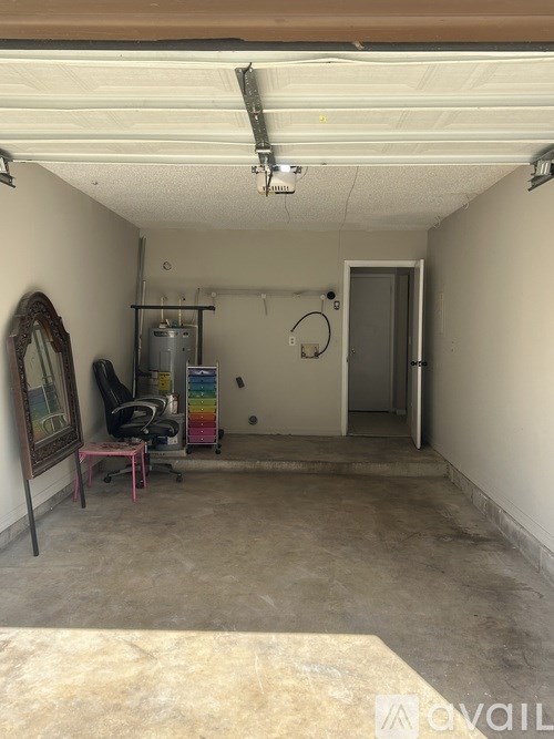 A room with a white ceiling and a door on the right side.