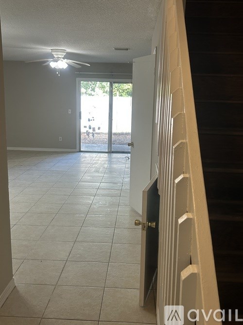 A room with a tiled floor and a ceiling fan.
