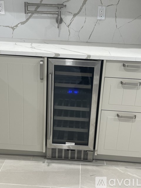A stainless steel oven with a digital display is in a kitchen.