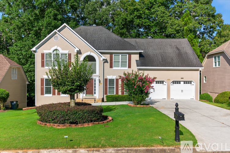 A house with a brown roof and a white garage door.