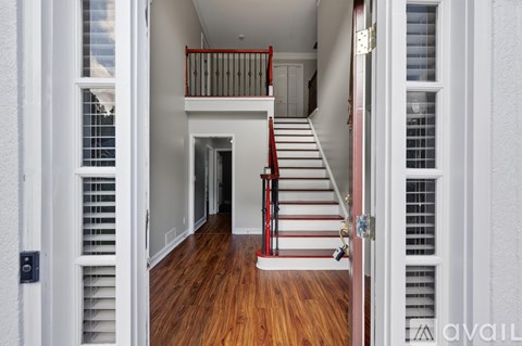 A white house with a red staircase.