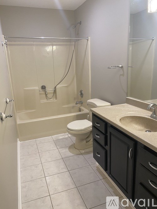A bathroom with a toilet, sink, and bathtub.