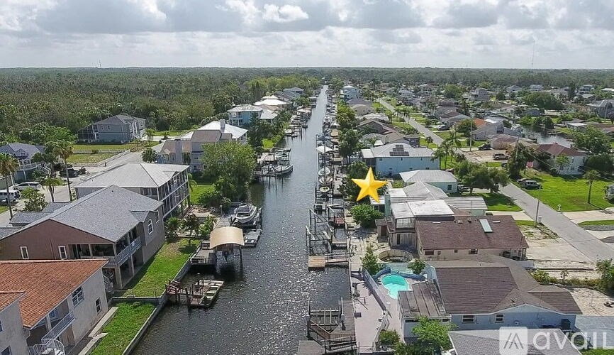 A canal in a residential area with houses on both sides.