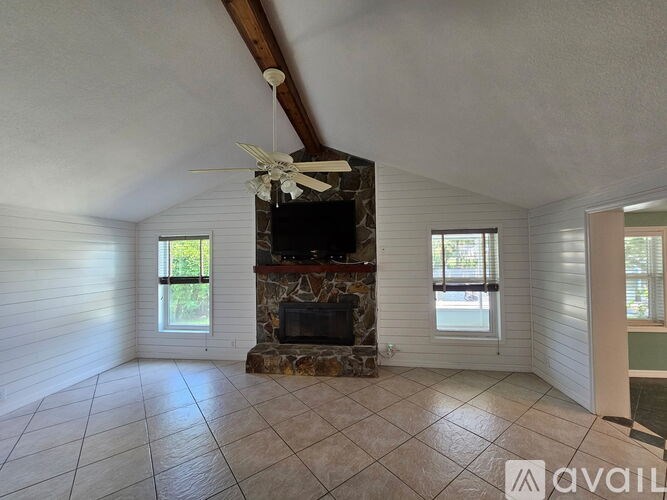 A living room with a fireplace and a television.
