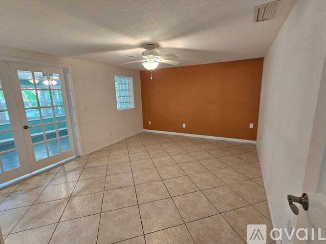 A room with a tiled floor and a ceiling fan.
