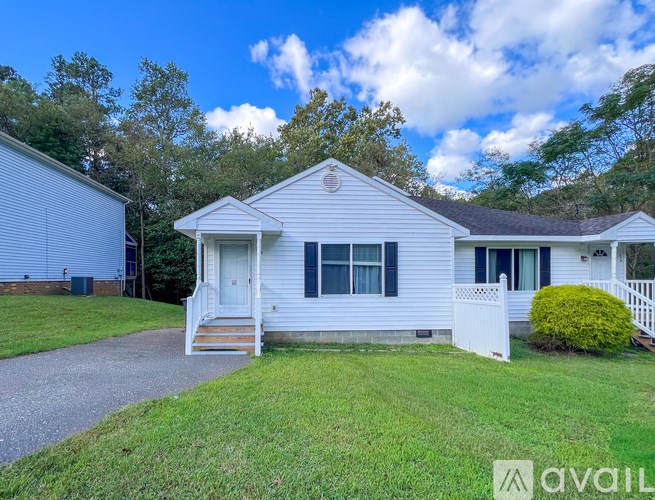 A house with a white front porch and a white picket fence.