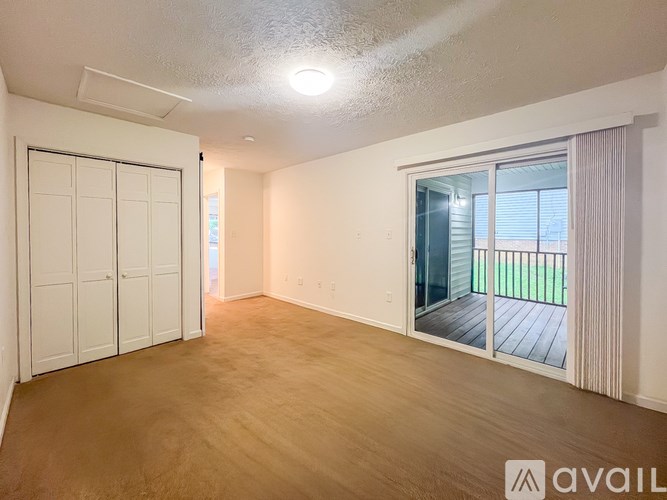 A room with a sliding door leading to a balcony.