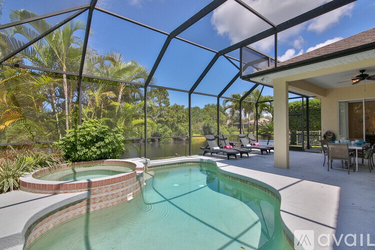 A glass enclosed outdoor area with a pool.