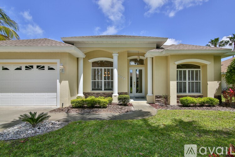 A house with a white garage door and a brown roof.