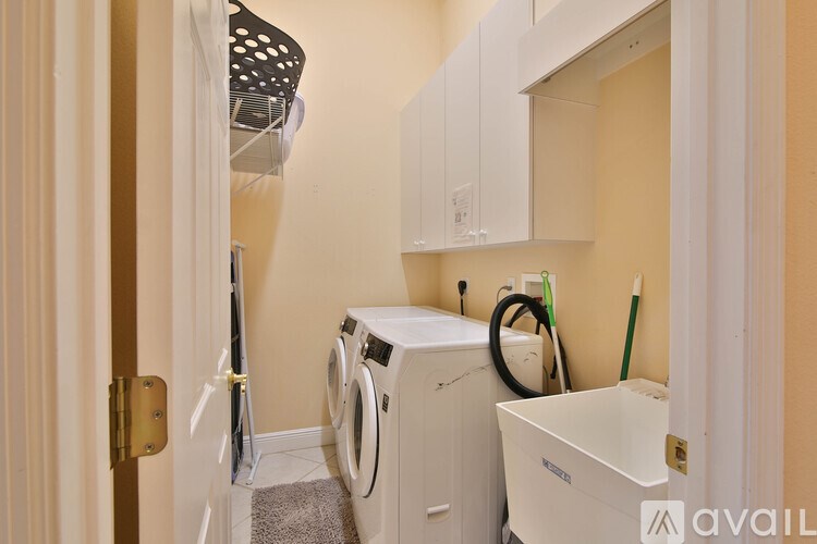 A small laundry room with a washer and dryer.