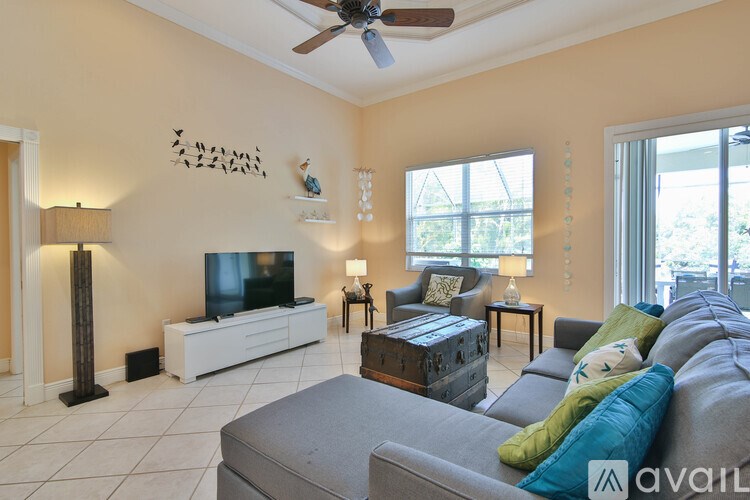 A living room with a grey couch and a television.