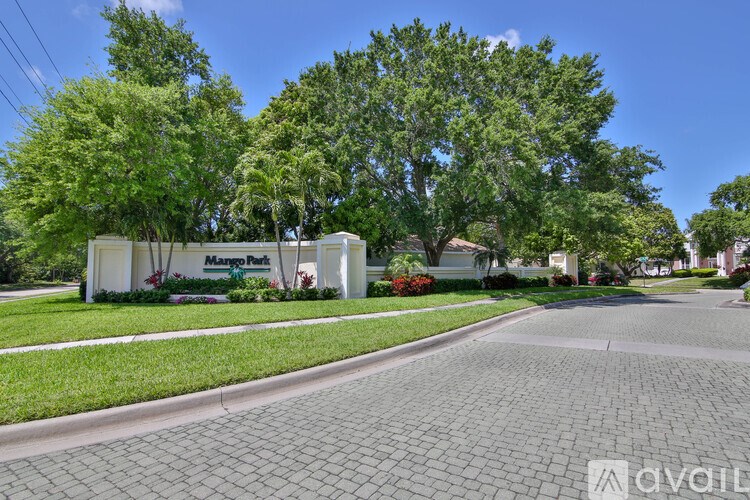 A sunny day at Mango Park with a clear blue sky and lush green trees.