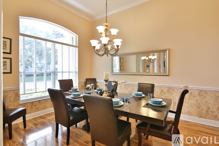 A dining room with a table set for six.