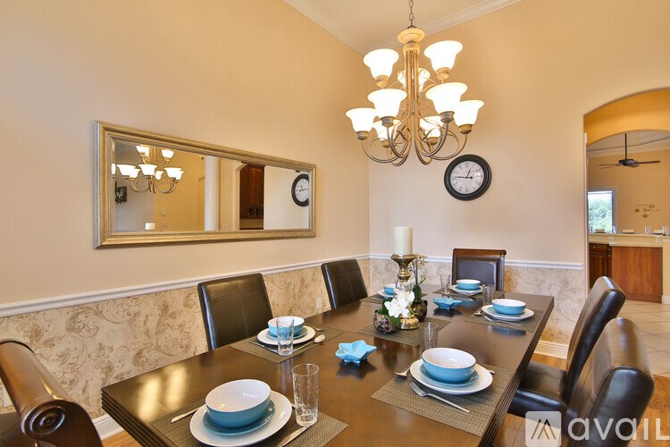 A dining room with a table set for six.