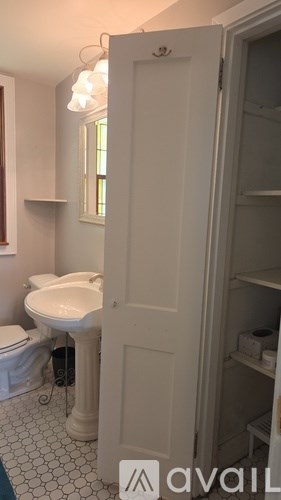 A white bathroom with a sink and toilet.
