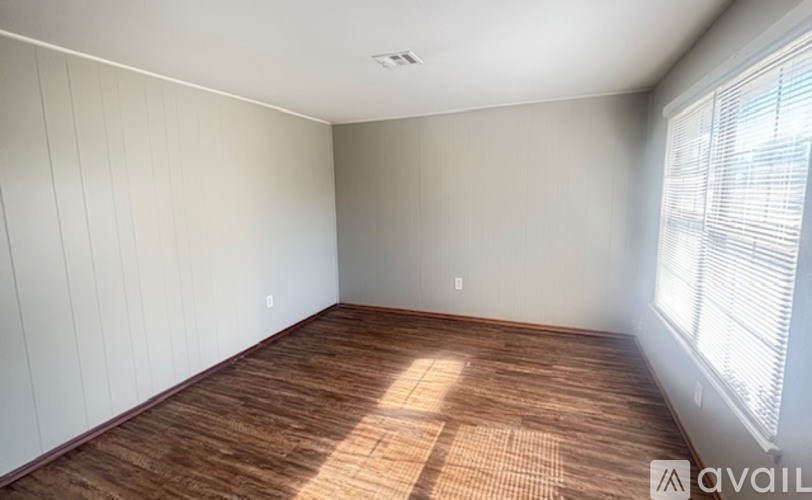 A white door is in a room with a brown mat in front of it.