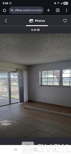A room with a sliding glass door and a window.