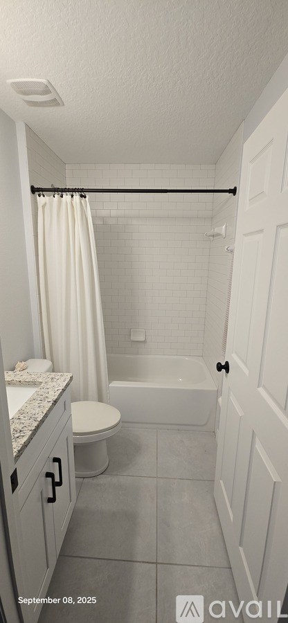 A bathroom with a toilet, sink, and bathtub.