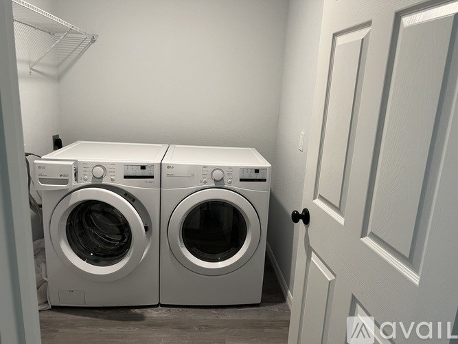 Two front load washing machines in a laundry room.