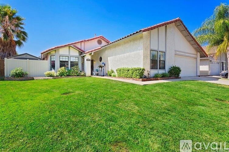 A house with a red roof and a white garage door.