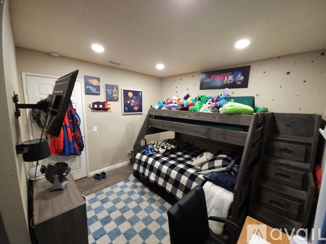 A room with a bunk bed and a TV.