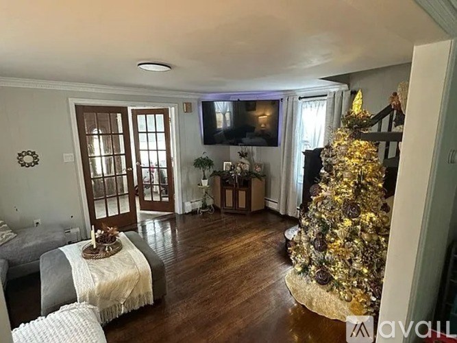 A Christmas tree is in the corner of a living room.