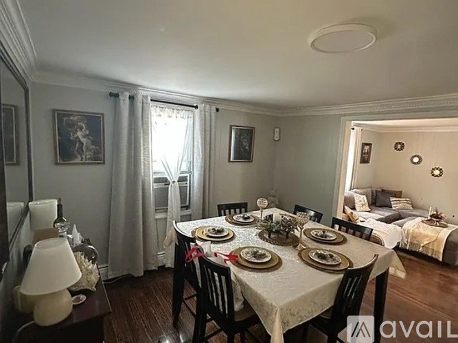 A dining room with a table set for a meal.
