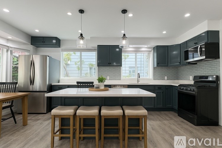 A modern kitchen with dark wood cabinets and a white island.