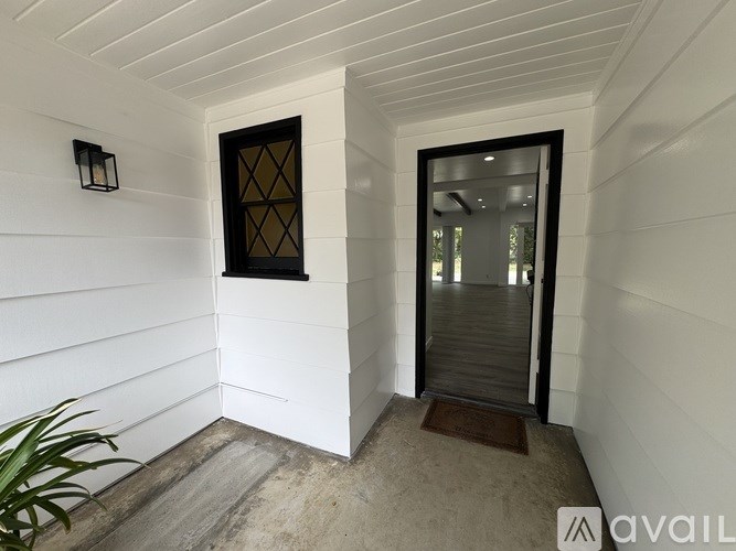 A white house with a black door and window.