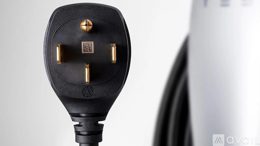 A silver electrical outlet with a black cover and a green light.