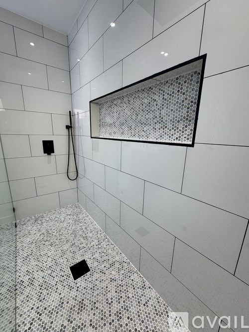 A bathroom with a shower and a tiled floor.