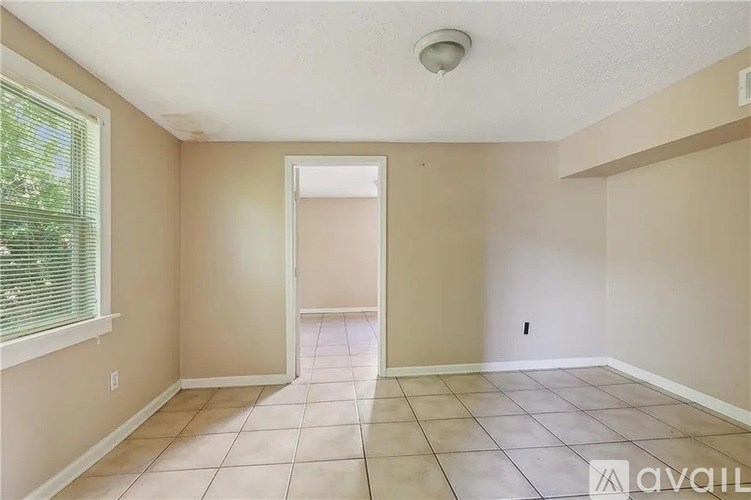 A room with beige walls and a tiled floor.