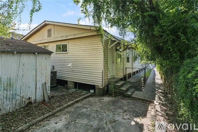 A house with a shed and a driveway.