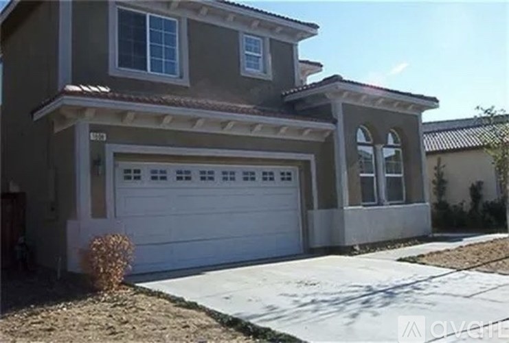 A two-story house with a white garage door.