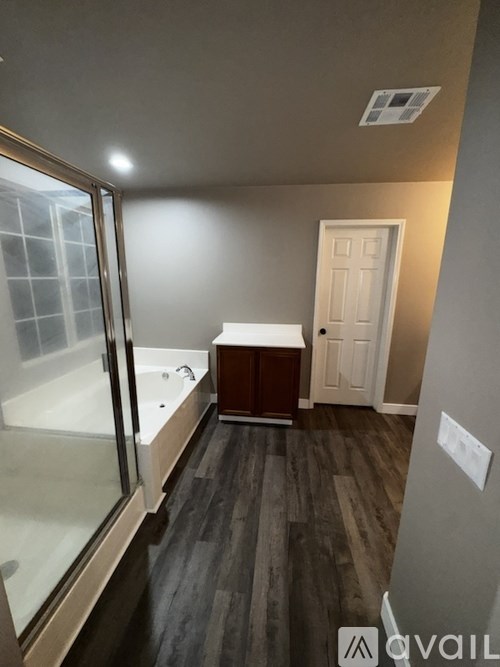 A bathroom with a tub and a toilet.