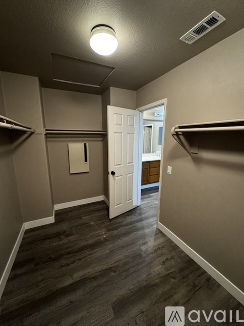 A hallway with a white door and a light on the ceiling.