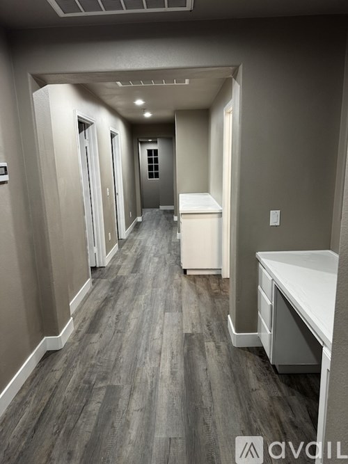 A long hallway with a white counter on the right.