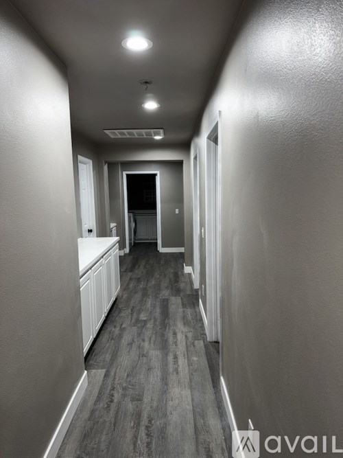 A long hallway with a door at the end.