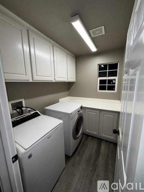 A small laundry room with a washer and dryer.
